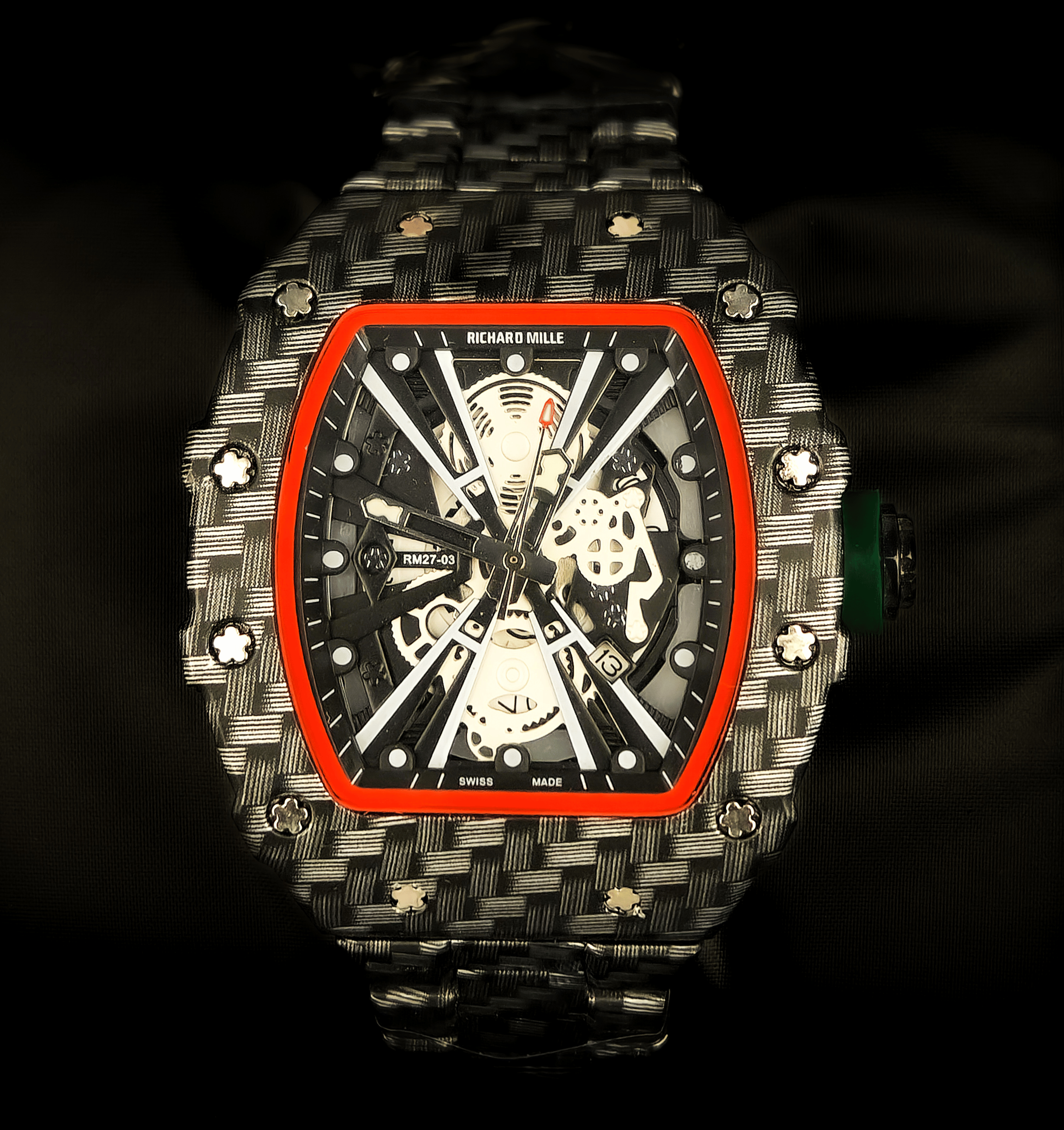 Luxury watch with a carbon fiber design on a dark background